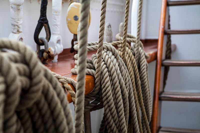Coiled mooring ropes and rigging aboard a ship